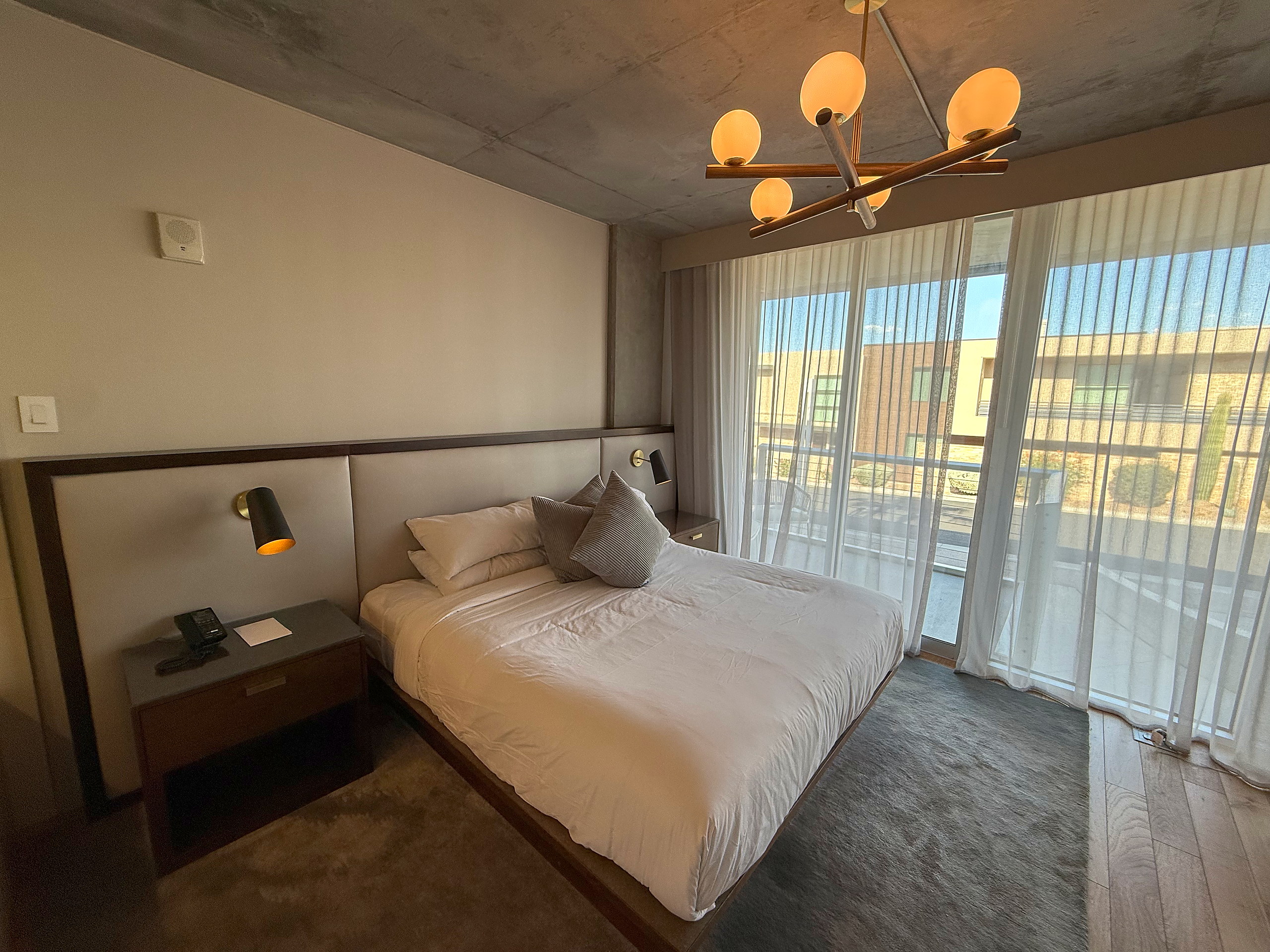Second bedroom with king bed, nightstands and chandelier