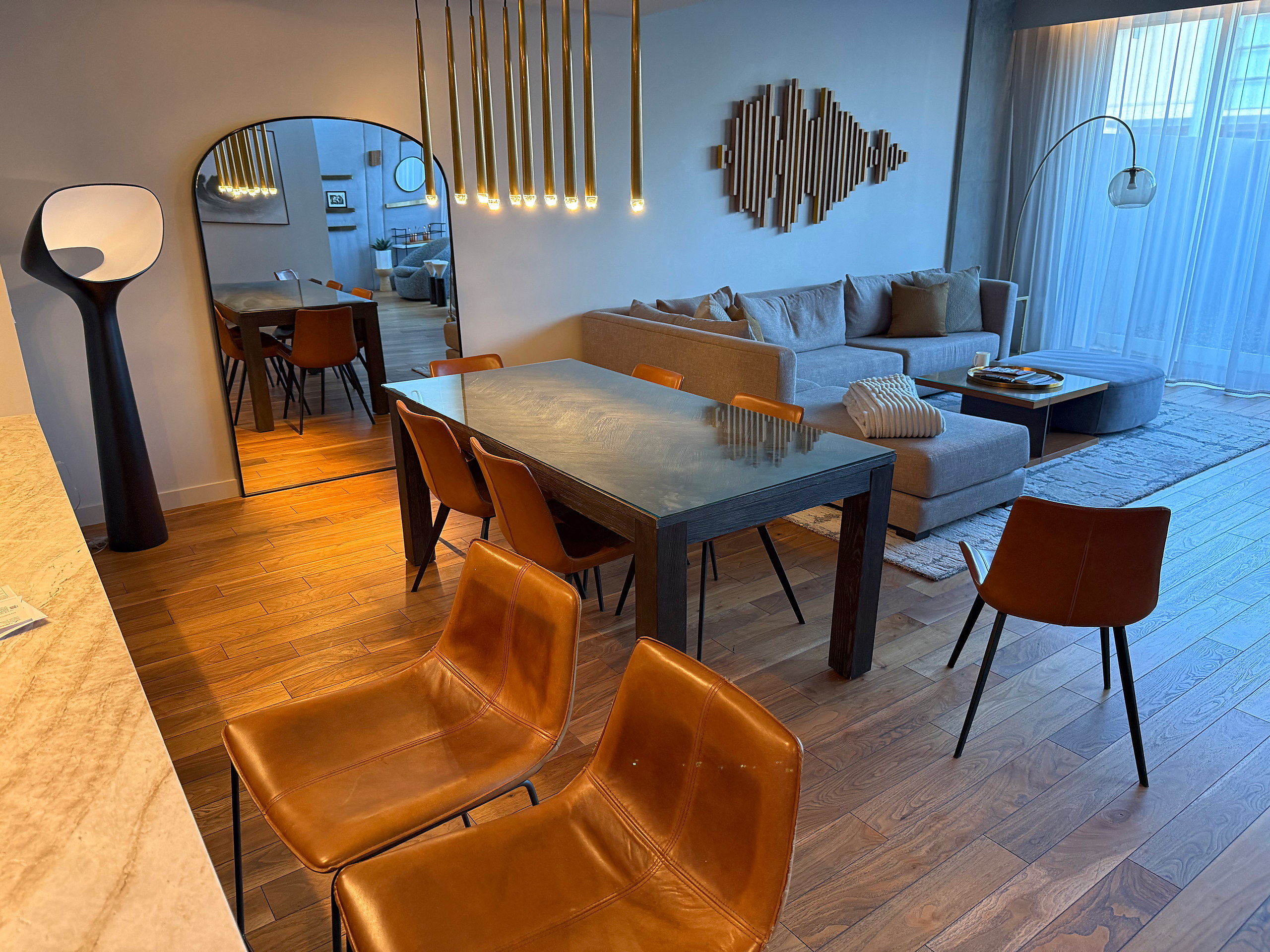 Dining table set for six beside the sectional