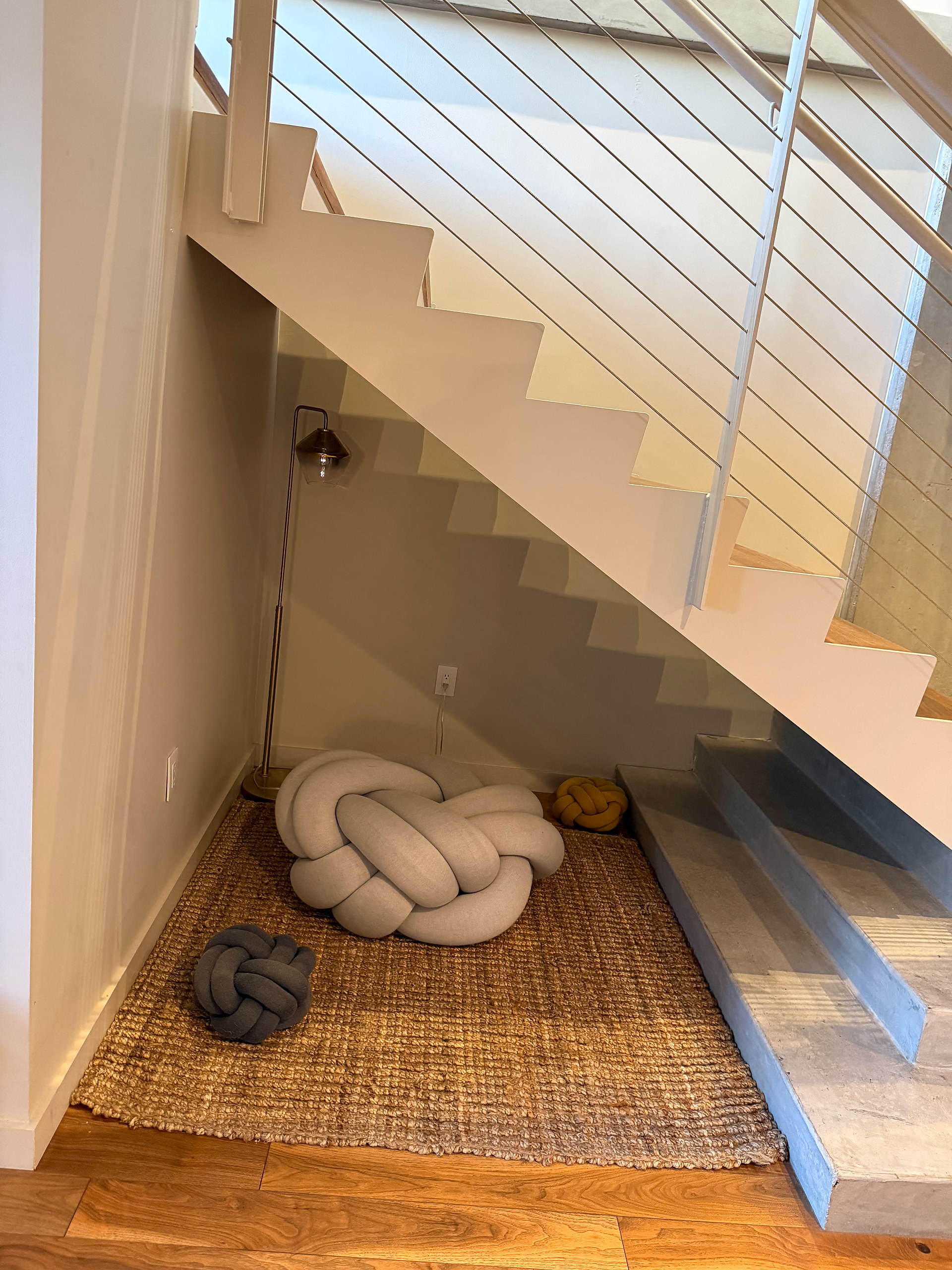 Knot floor cushions and jute rug in the stair nook
