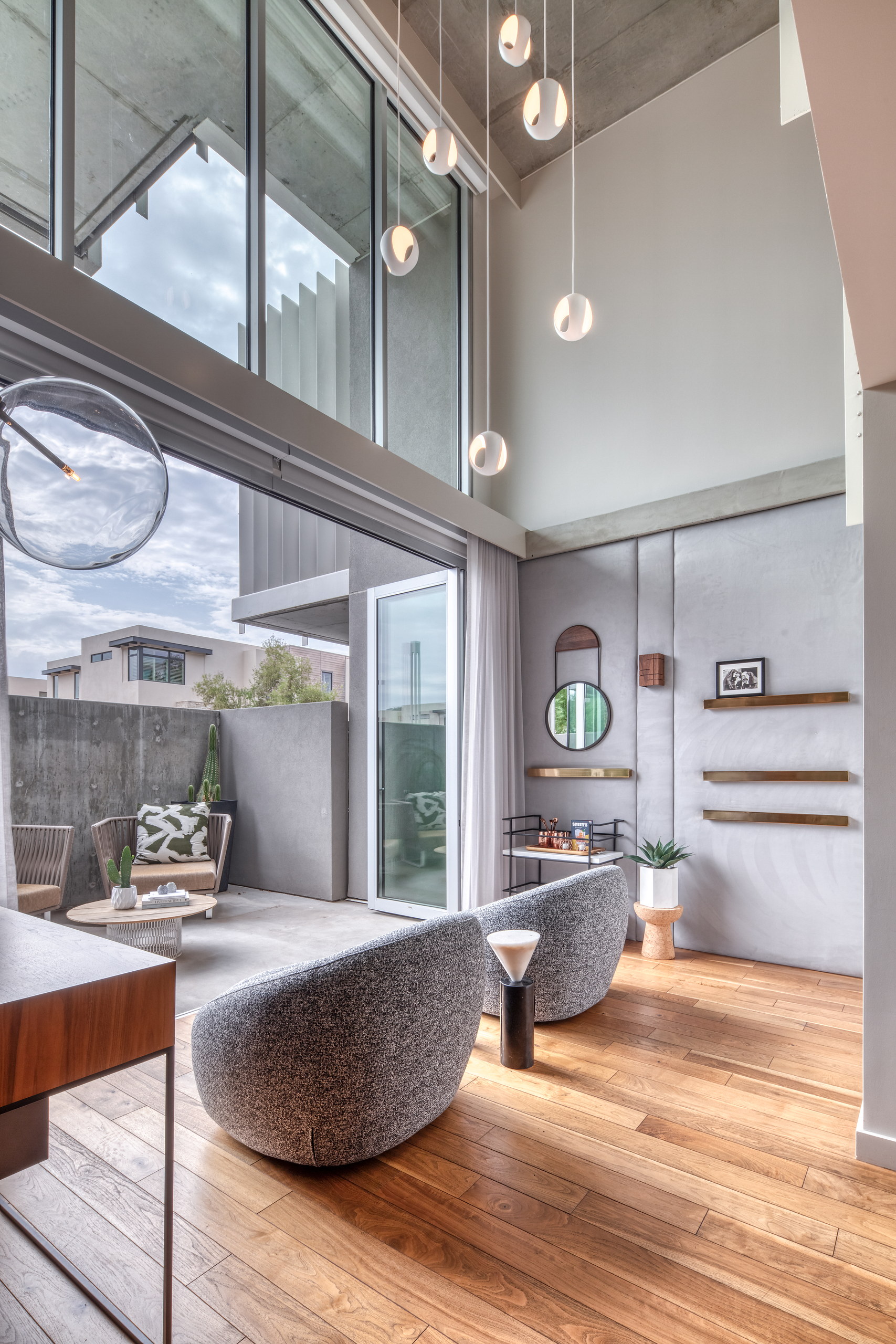 Sitting room with mirror and brass wall shelves