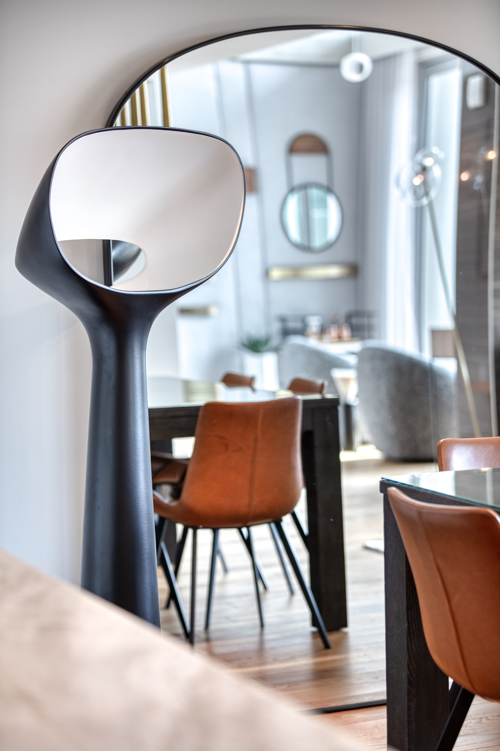 Sculptural floor lamp and leather dining chairs